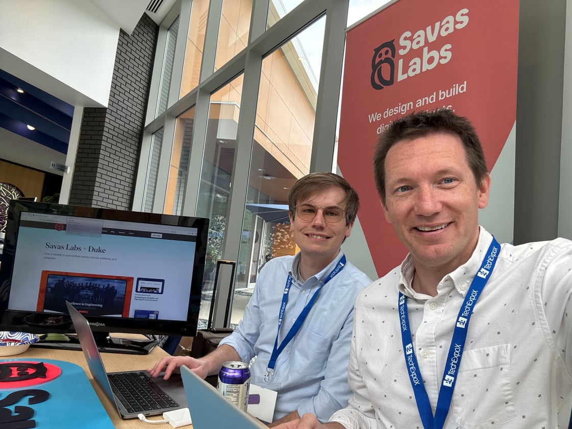 Ben and Sean at Duke with Savas merch