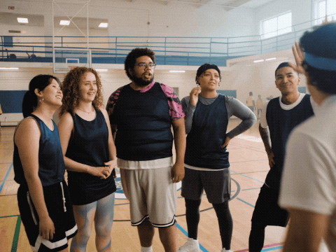 guy in a gym giving high fives to his team